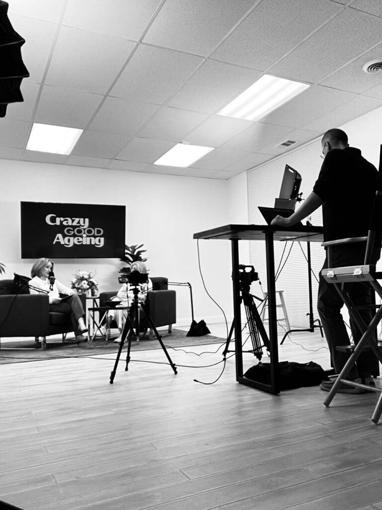podcast studio with hosts, video equipment, and a director